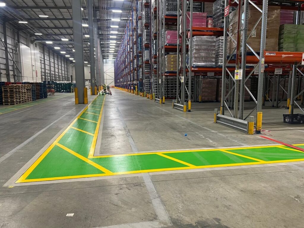 Safety walk signs and anti-slip walkway markings installed in a warehouse